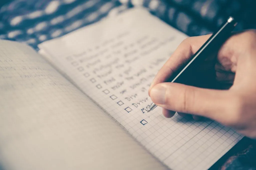 person writing on a notebook